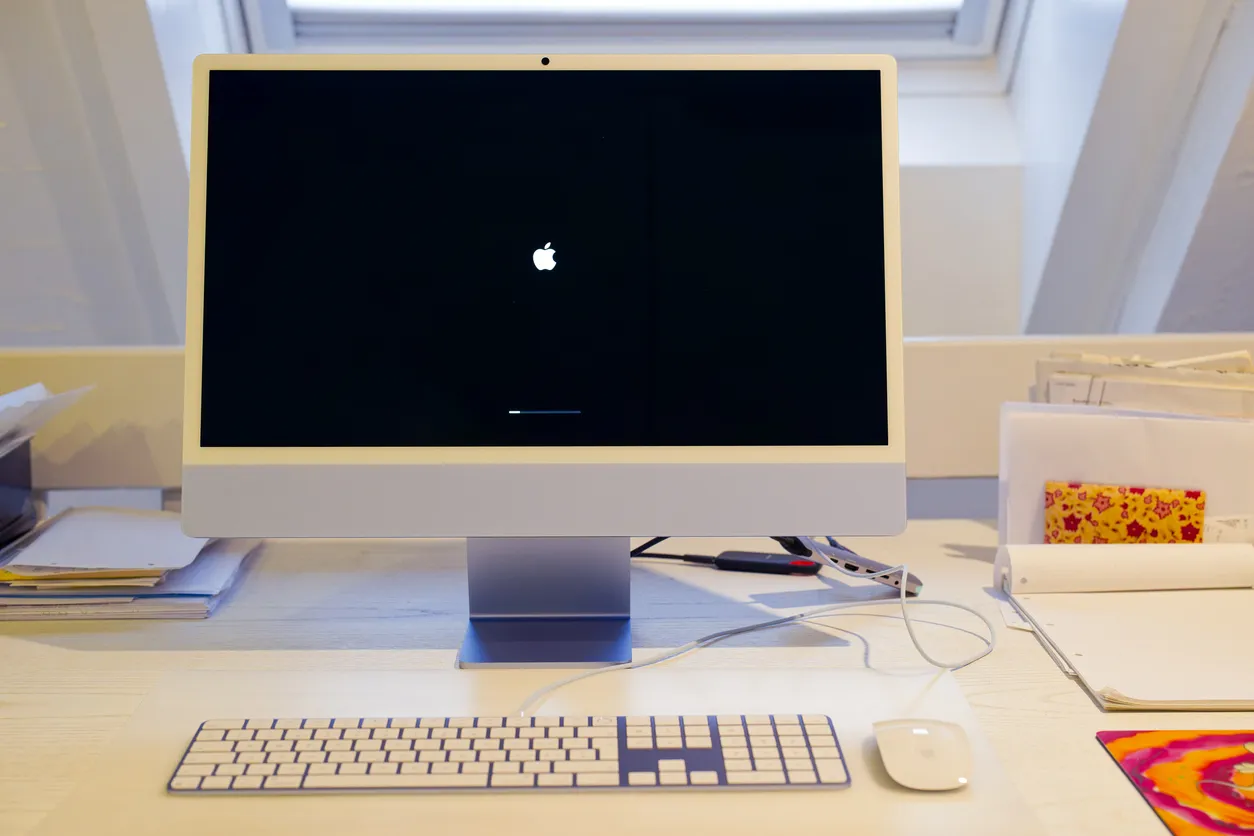 Mac mini and monitor on a desk in an office