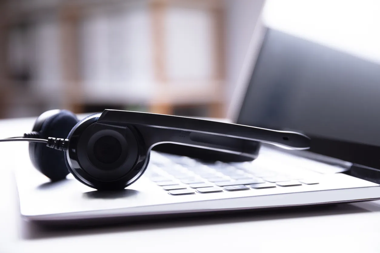 Desk phone, headset and laptop on a Sydney office desk running a VoIP business phone system
