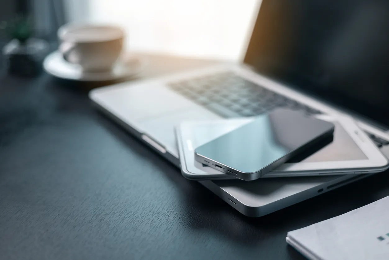 Laptop and smartphone on a Sydney office desk representing managed business devices