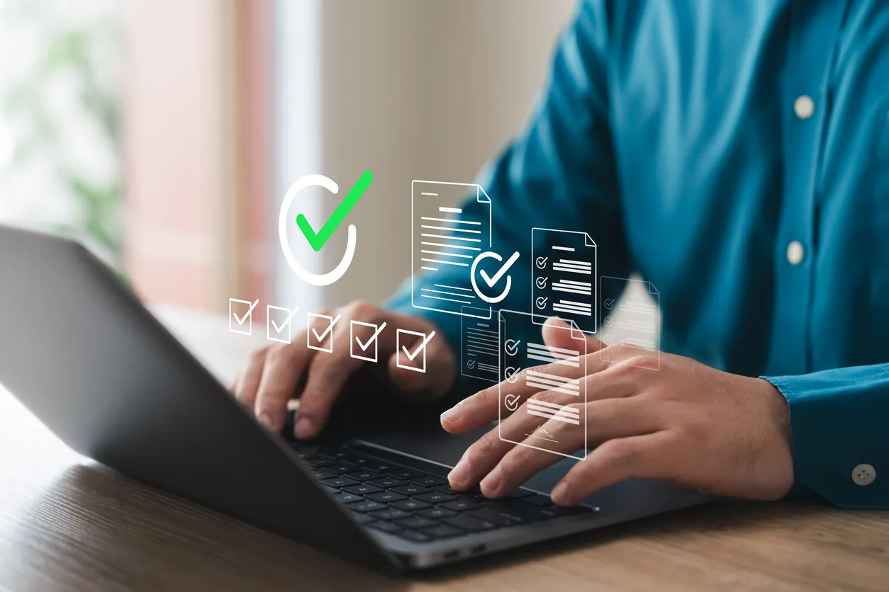 Checklist and laptop on a desk during a cyber security review in a Sydney office