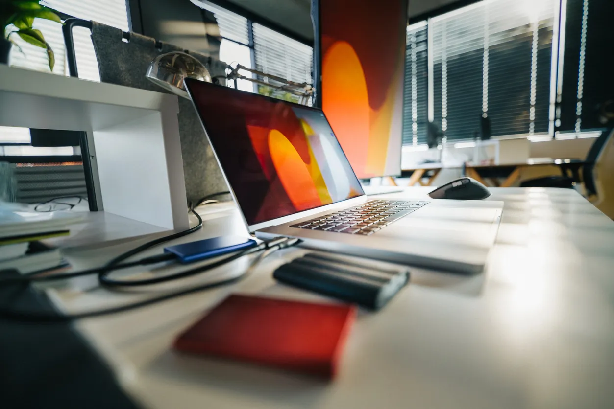 Laptop and backup drive on a Sydney office desk representing data protection
