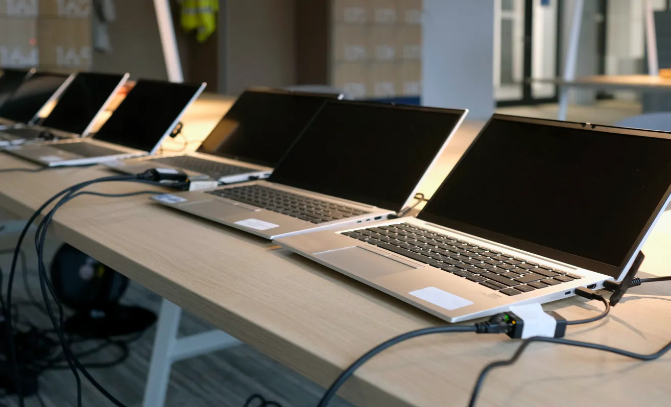Row of laptops and a desktop computer in a Sydney office ready for endpoint protection deployment