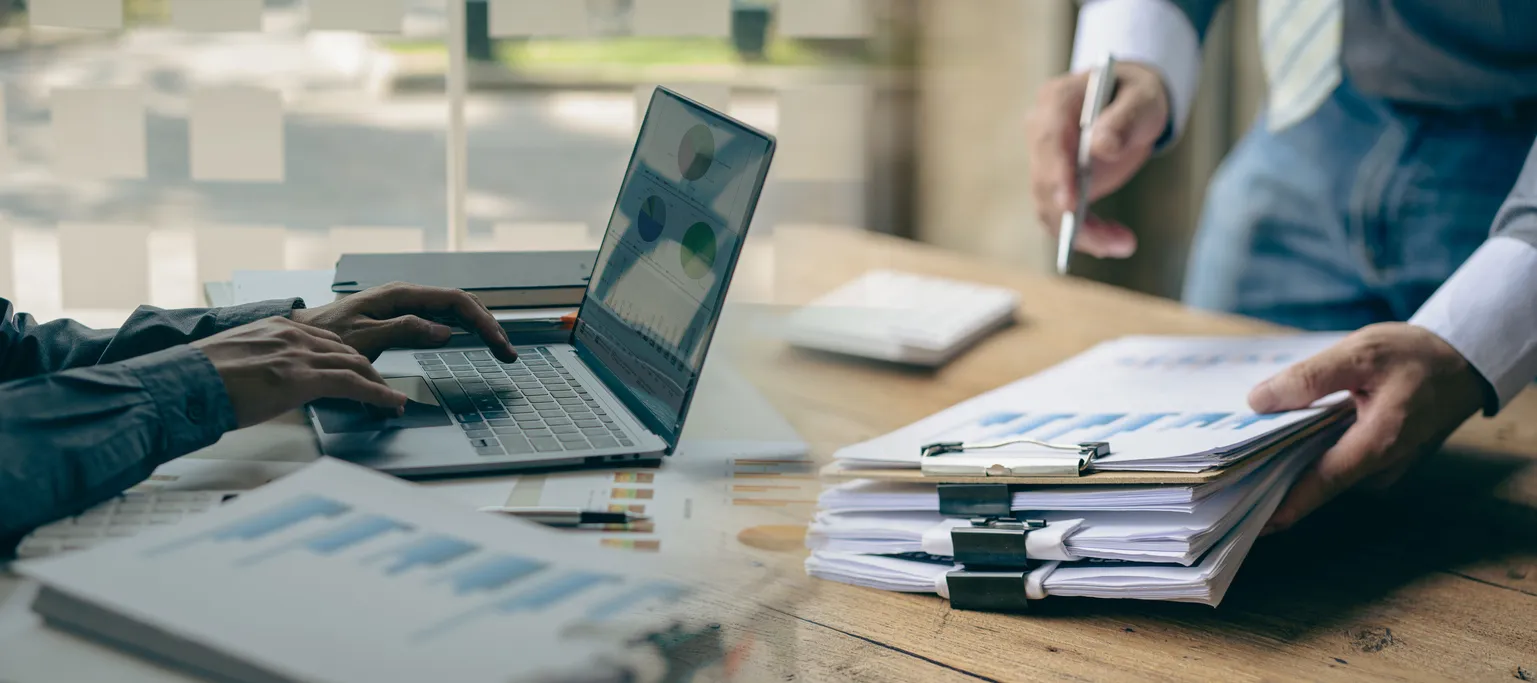 Desk with laptop and documents for evaluating a managed services provider in Sydney