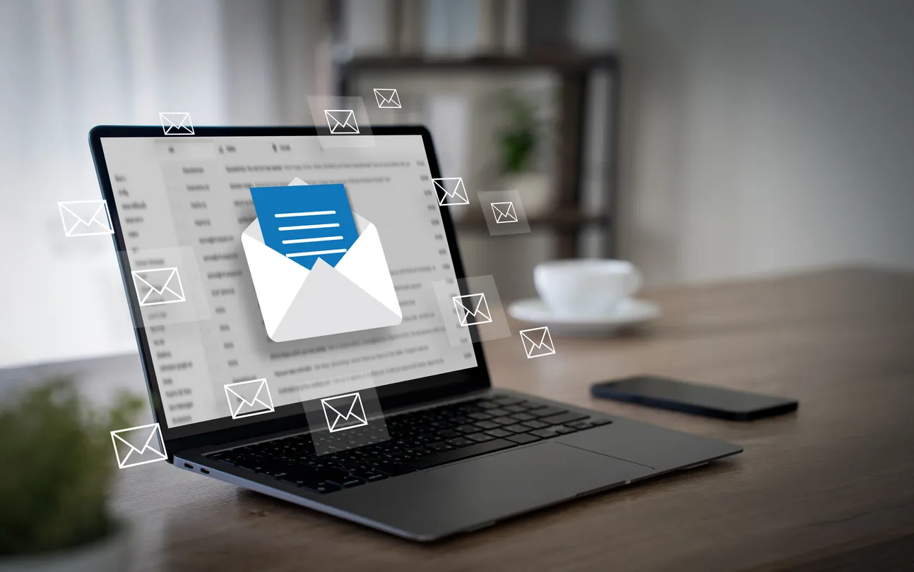 Laptop on a Sydney office desk showing an email inbox during a Microsoft 365 migration