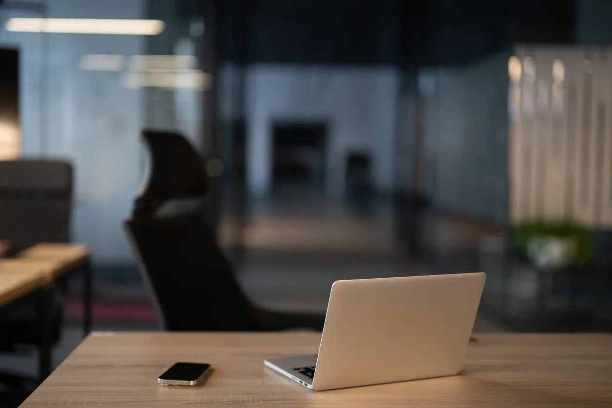 Small office desk with a VoIP phone and laptop in a Sydney business