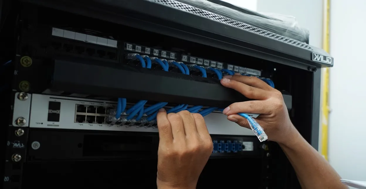 UniFi network switch and access point hardware mounted in a Sydney office comms rack