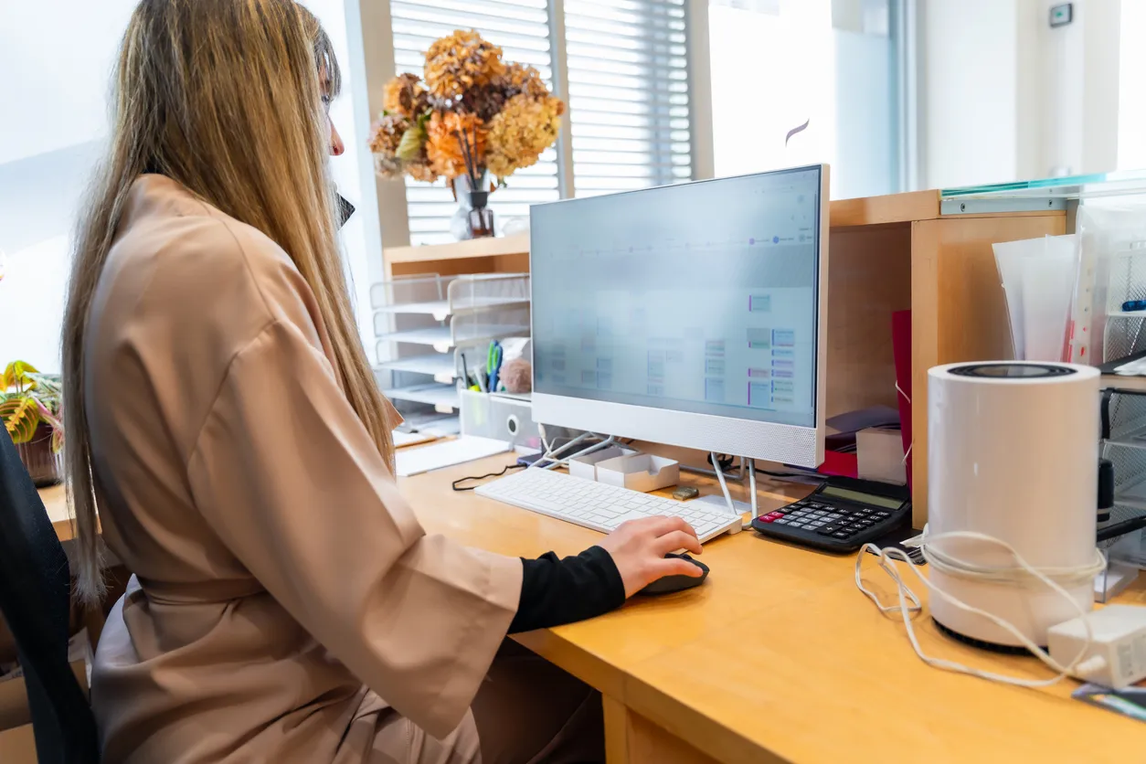 Nurse using a computer at a care facility reception desk