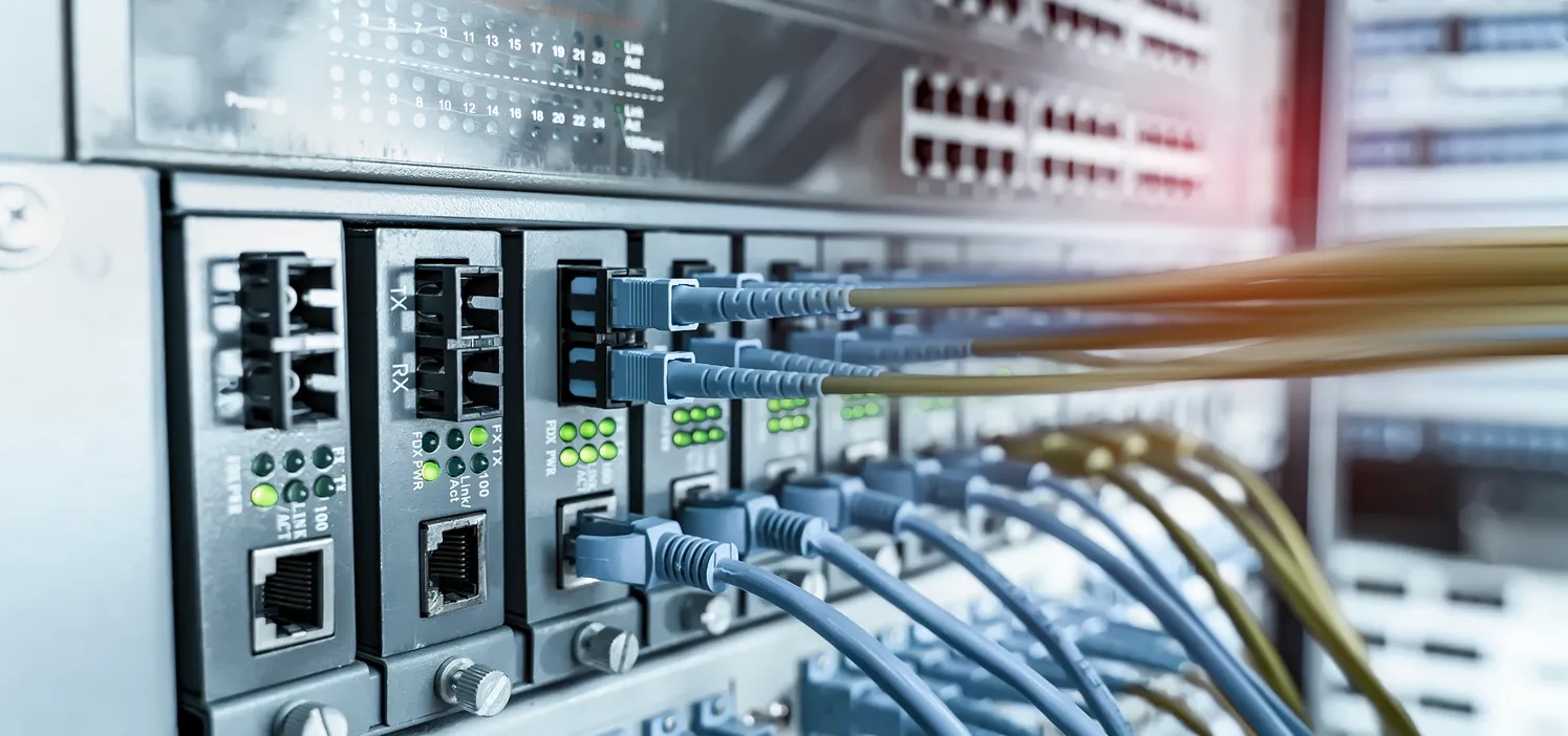 Network rack with business internet router and fibre connection in a Sydney office comms cabinet.