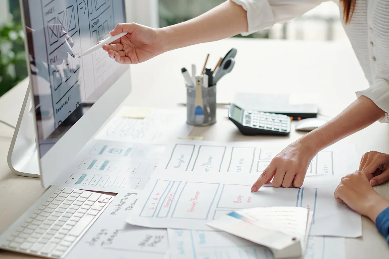 Planning the cost of a business website with a laptop and notes.