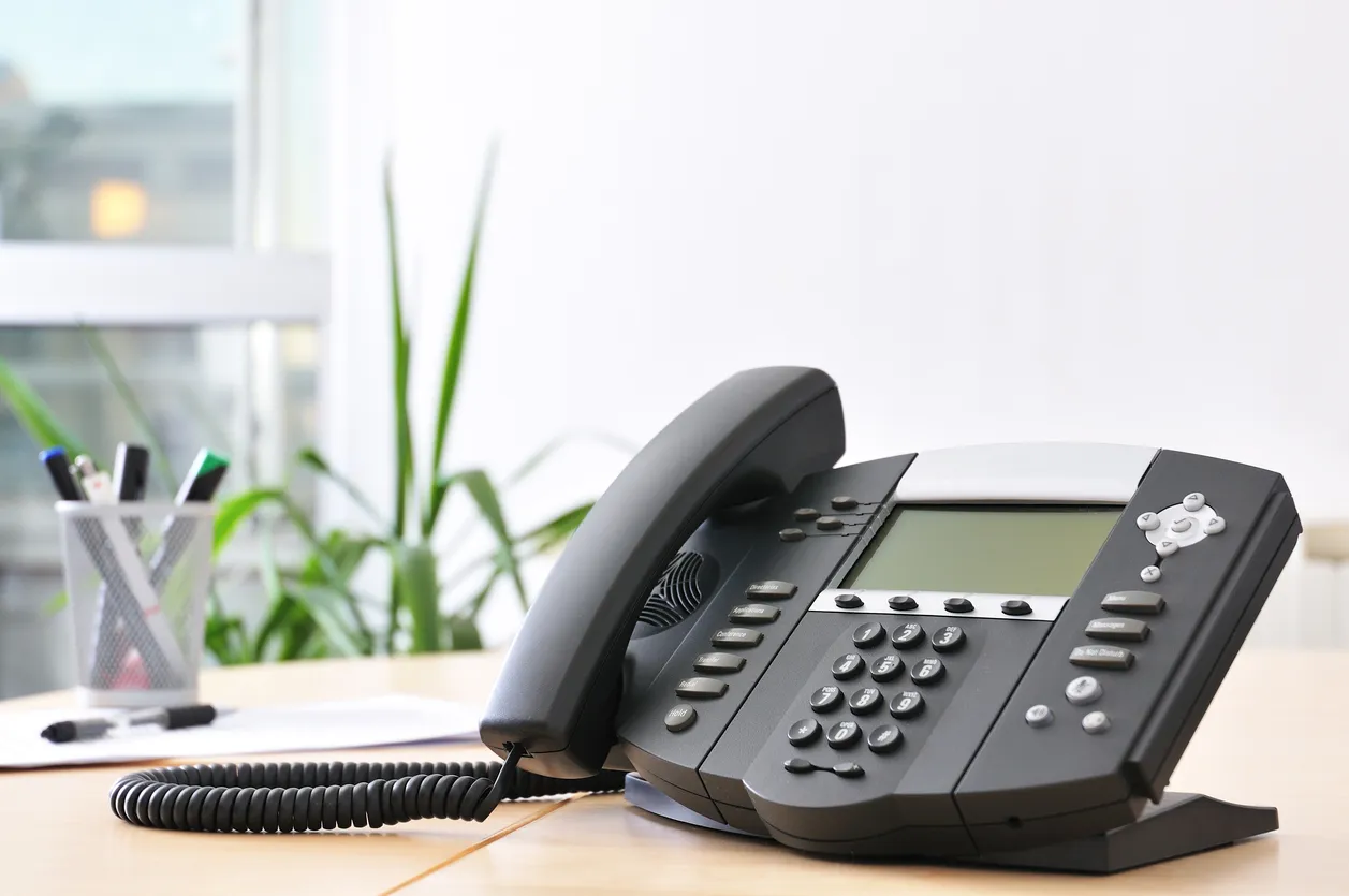 Business phone system running on a desk phone, laptop softphone, and mobile app.