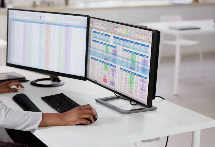 Two office screens showing data being copied automatically between business applications