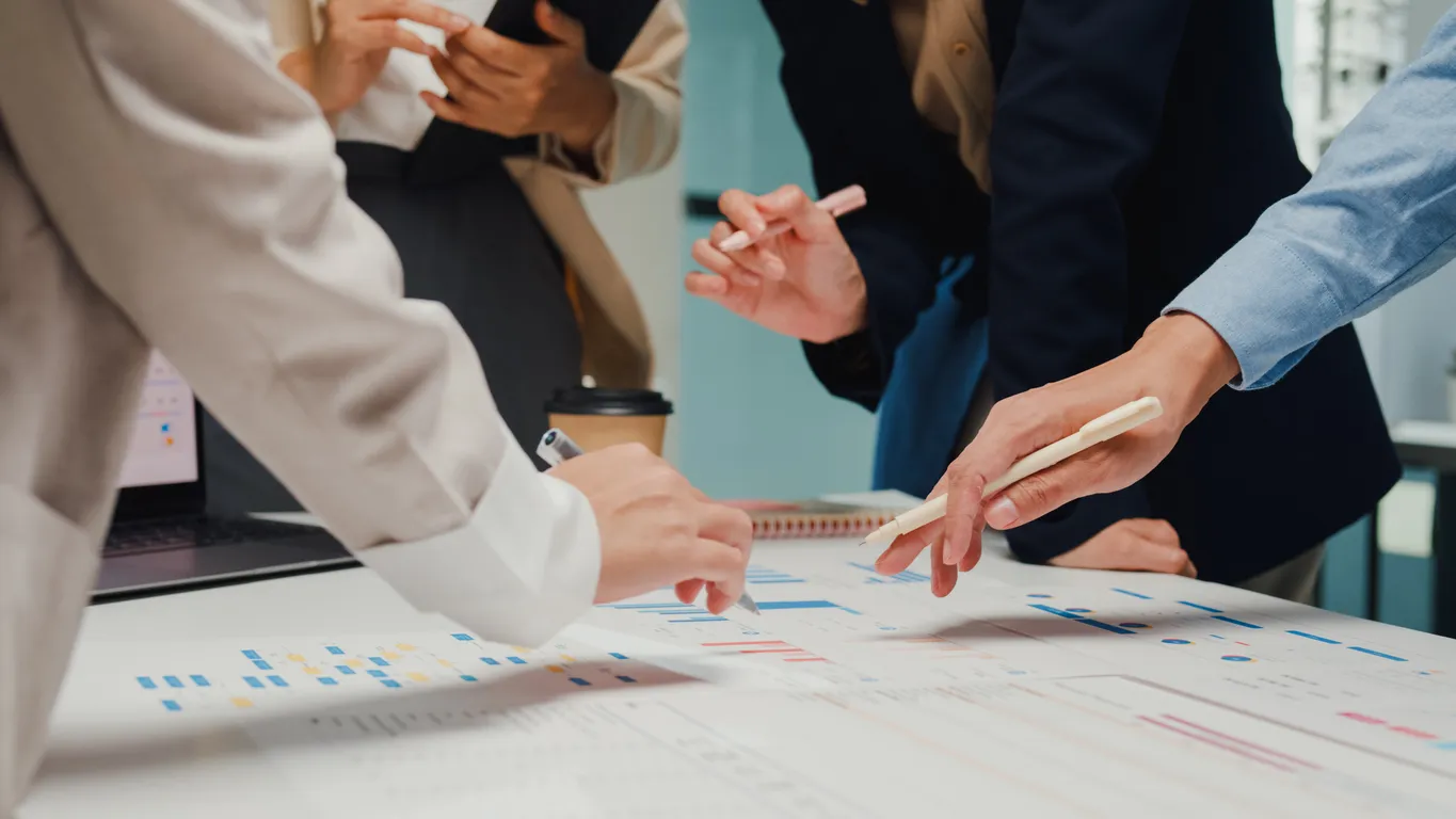 Business team reviewing a continuity plan document in an office.