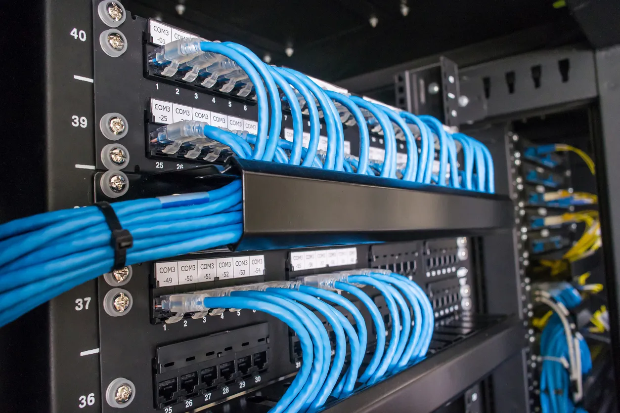Business firewall appliance mounted in a network rack with cabling.