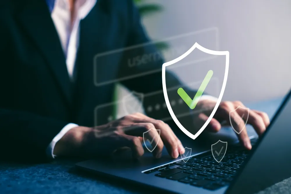 Person signing in securely on a laptop with a password manager prompt displayed.