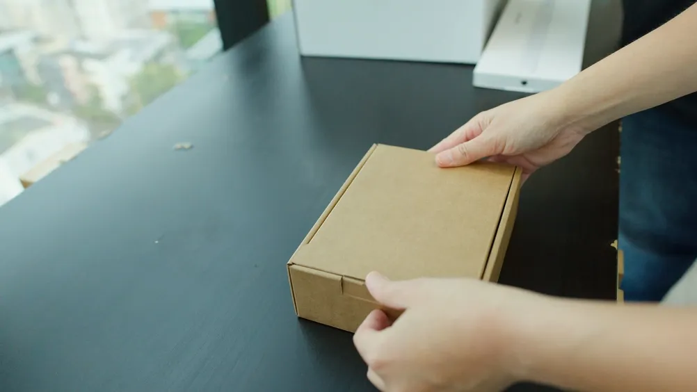 New MacBook and iPhone still boxed on an office desk