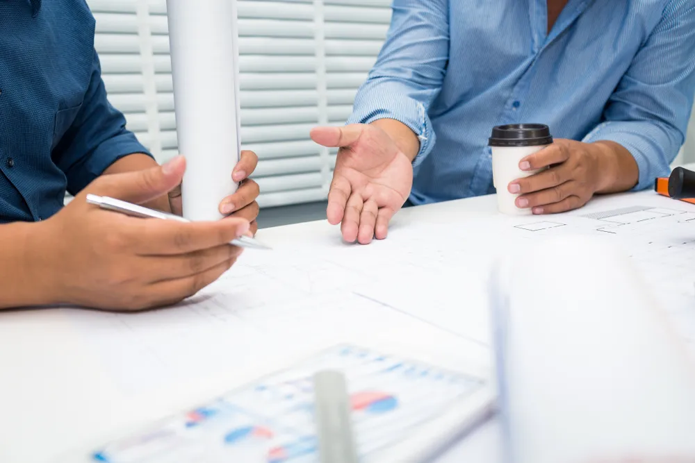 Printed plan document in a binder on a meeting room table