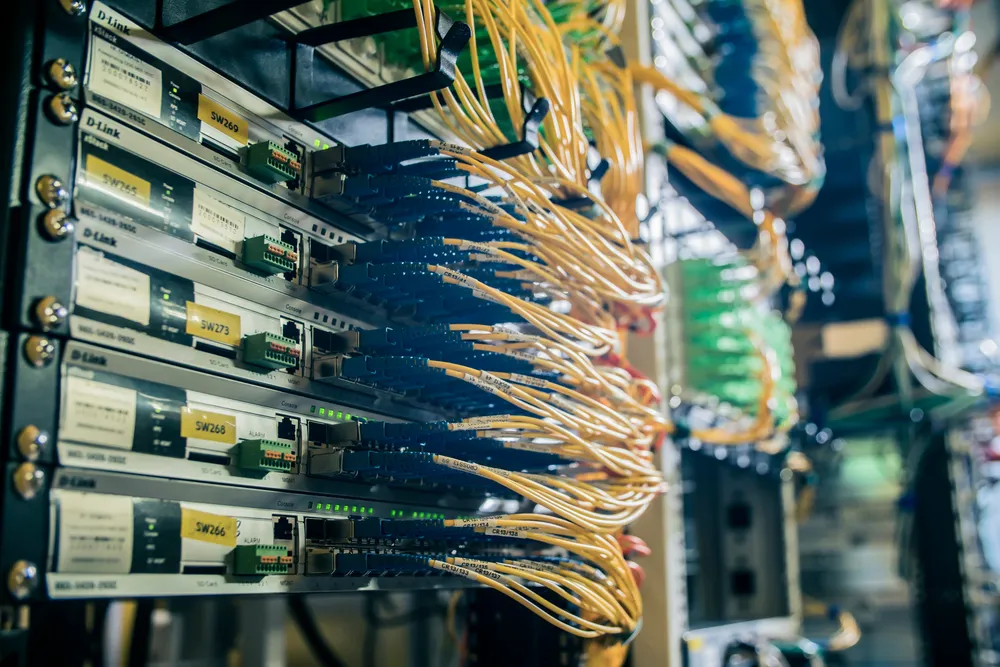 Server cabinet with network switches and cabling in a comms room