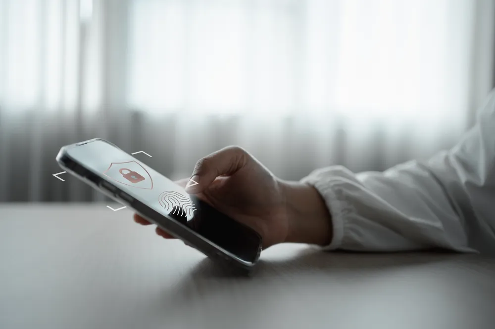 Staff member approving a sign-in notification on a mobile phone.