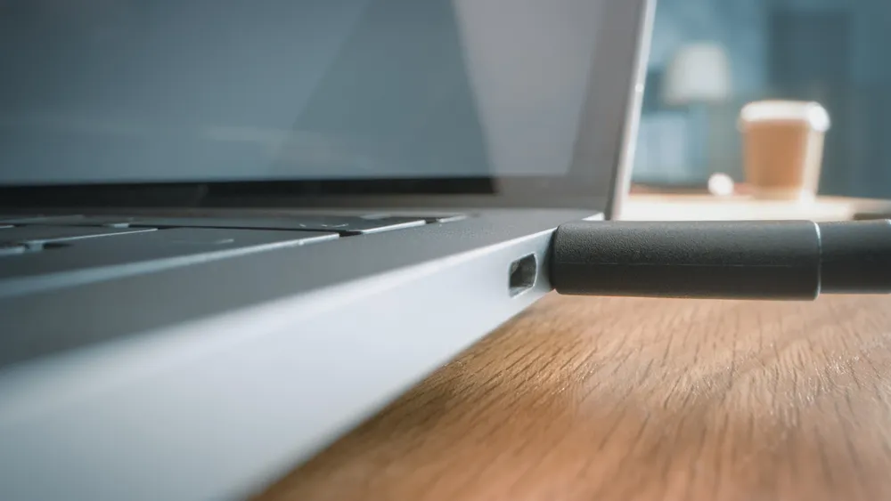 Laptop with an external USB drive plugged in on an office desk.
